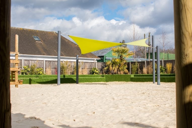 Green playground shade sail at Chobham Adventure Farm