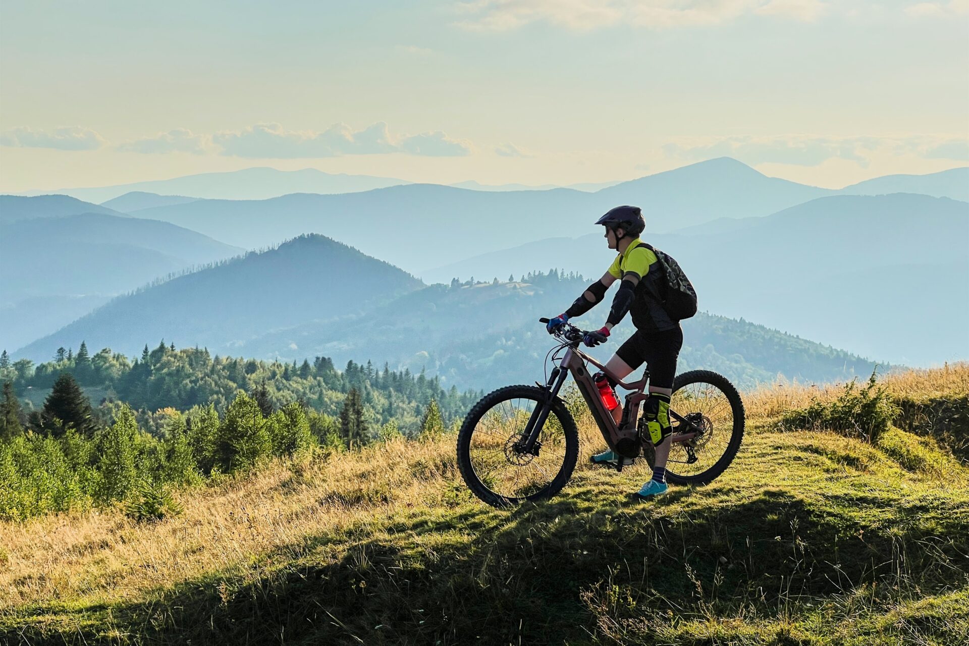 Cyclist man riding electric bike outdoors